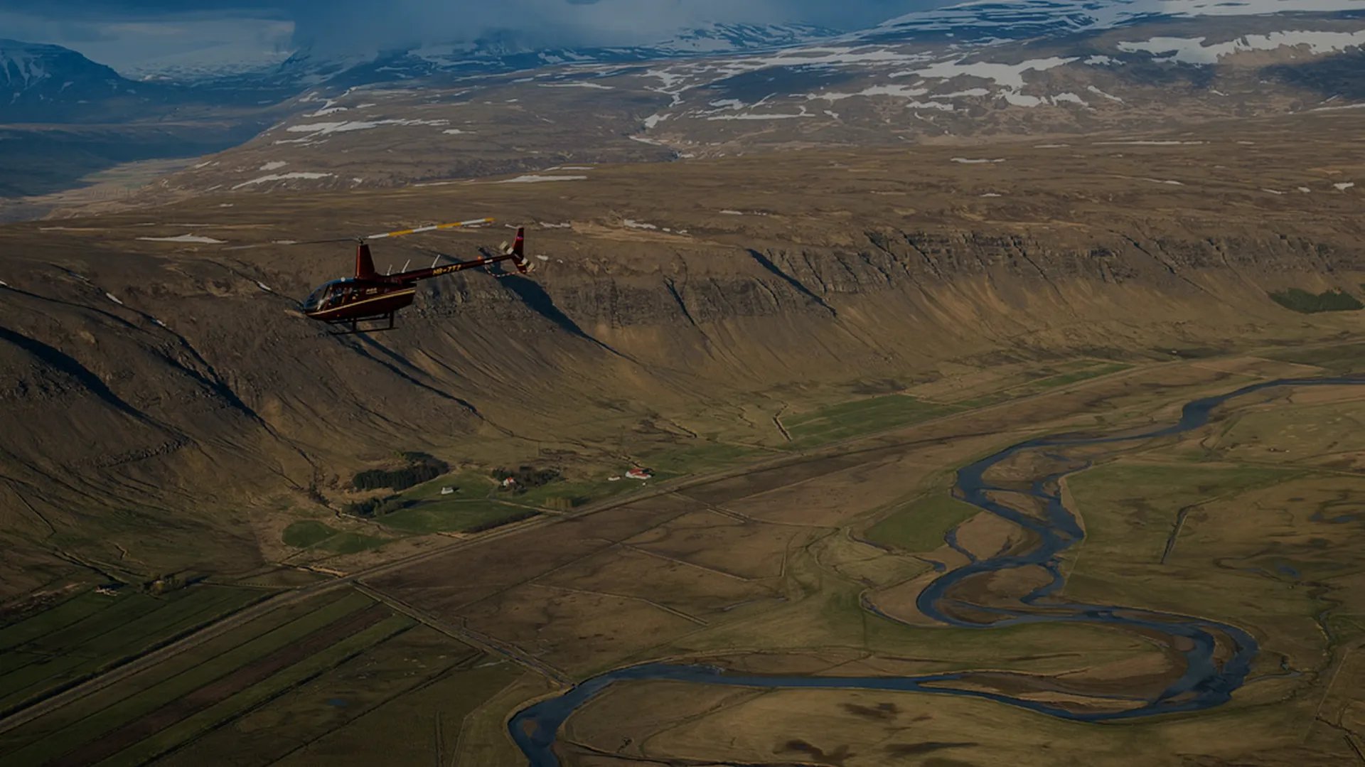Aerial view of Iceland's dramatic landscape with waterfalls and volcanic terrain