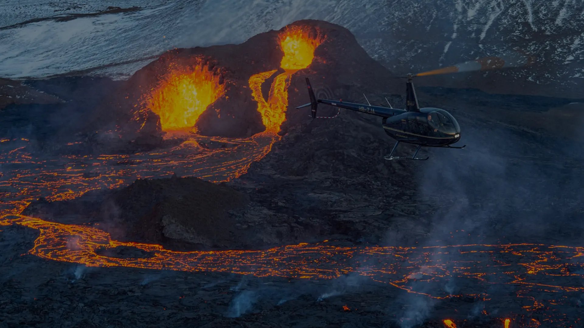 Aerial view of volcanic eruption with lava flows and smoke plumes