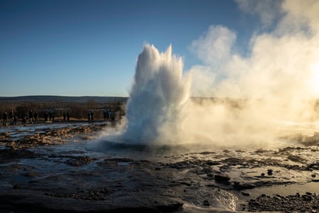Stone before a hot spring with the name Geysir engraved in it