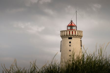 The lighthouse of Garður seen through the grass