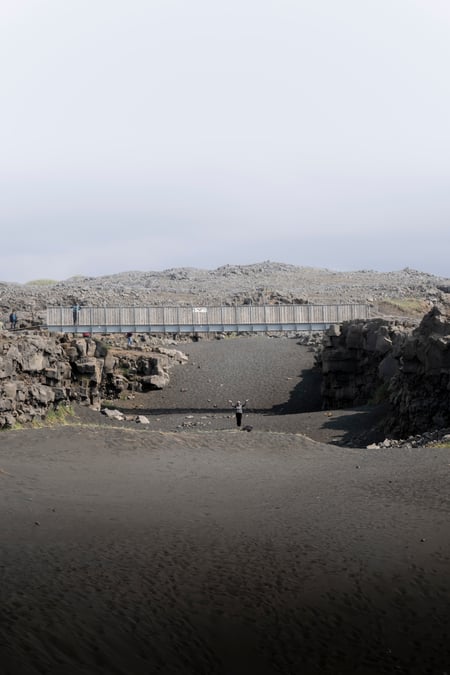 People under the brige between the continents on the Reykjanes Peninsula