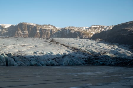 An icelandic glacier during a peaceful day, reflecting on calm waters