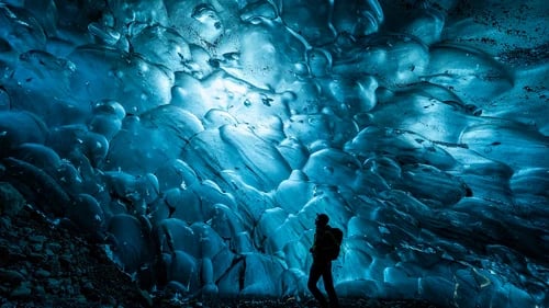 Adventurers exploring stunning blue ice cave formations in Vatnajökull glacier