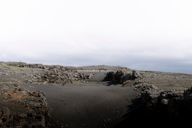 A person is under the bridge between Europe and America on the Reykjanes Peninsula.
