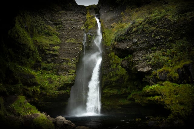 The waterfall of Gluggafoss, falling inside a cliff between natural windows