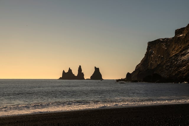A black sand beach in Iceland and the famous pillars of Reynisdranger