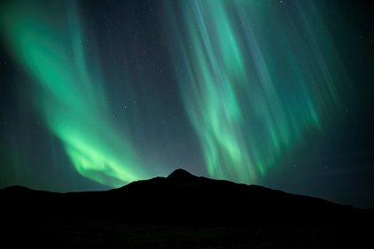 Spectacular Northern Lights dancing over Iceland landscape