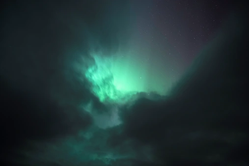 Northern Lights peaking through the clouds