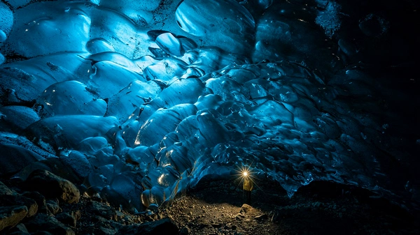 Glacier hikers traversing pristine ice fields with crampons and safety gear