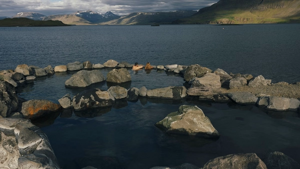 People enjoying the warm waters of the Hvammsvík Hot Springs
