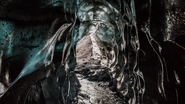 Striped ice formations with volcanic ash layers in Katla ice cave