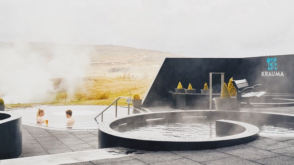 Modern Krauma geothermal spa facility with mountain backdrop