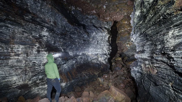 Hidden lava fall cascading through ancient volcanic tunnel formations