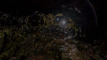 Spectacular lava tunnel interior with hidden underground waterfall