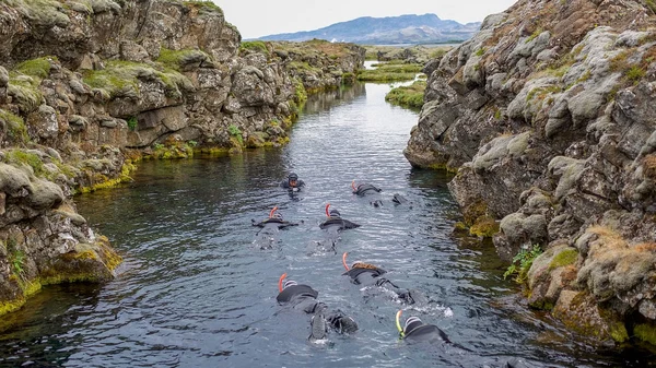 Snorkeler floating in crystal-clear waters of Silfra fissure