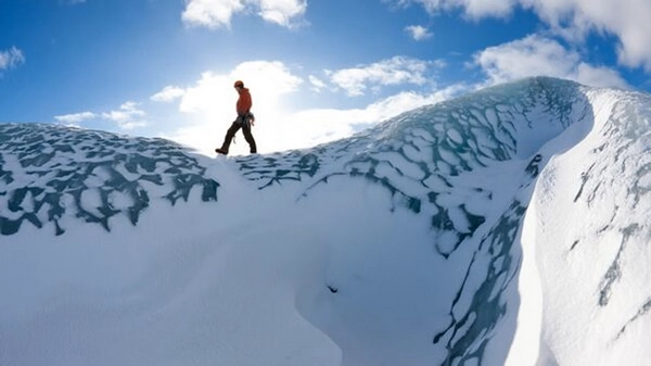 Panoramic view of Sólheimajökull glacier tongue descending from mountains