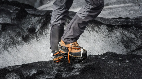Hikers with crampons exploring dramatic Sólheimajökull glacier crevasses