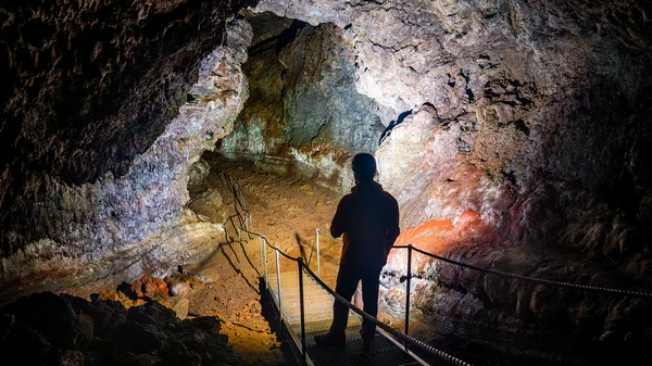 Group tour descending into the depths of Vatnshellir lava cave