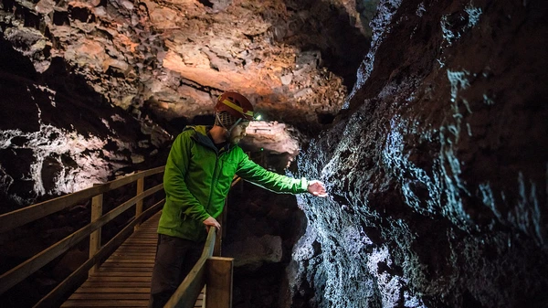 Spectacular volcanic rock formations illuminated by professional cave lighting