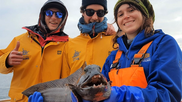 Family enjoying both fishing and whale watching from comfortable boat deck