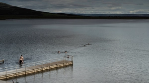 People swimming inside the lake Laugarvatn