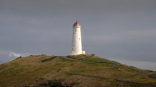 A beautiful lighthouse, standing on the top of a hill