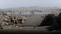 People under the brige between the continents on the Reykjanes Peninsula