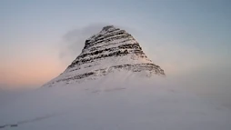 The snow-capped top of Mount Kirkjufell at sunrise
