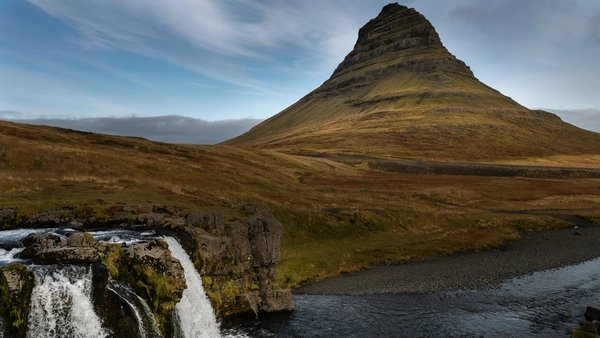 Two waterfalls are flowing before the majestic mountain of Kirkjufell
