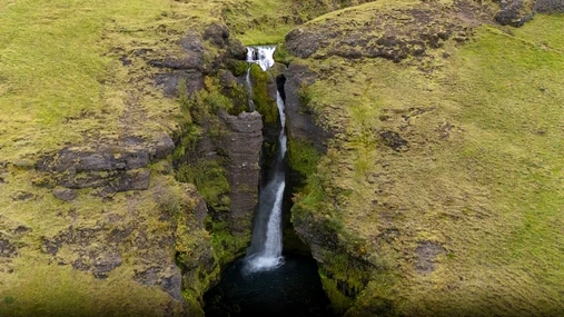 The waterfall of Gluggafoss, falling inside a cliff between natural windows