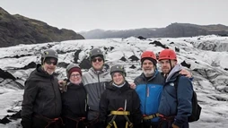 Happy family on during a glacier hike tour in Iceland