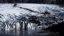The glacier of Sólheimajökull and the people about to go hiking on it