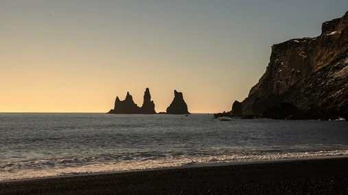 A black sand beach in Iceland and the famous pillars of Reynisdranger